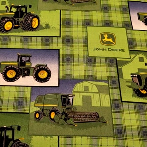 May include: Green and yellow John Deere fabric with a plaid pattern. The fabric features images of tractors, combines, and barns.