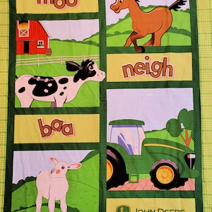May include: A farm-themed fabric panel featuring illustrations of farm animals and a tractor. The panel includes a red barn, a cow, a horse, a sheep, and a John Deere tractor. The words "moo", "neigh", and "baa" are also displayed.