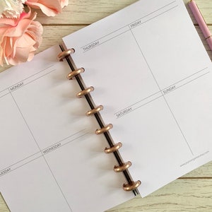 May include: A white weekly planner with a rose gold coil binding. The planner has spaces for notes, Monday through Sunday, and a section for the week commencing.