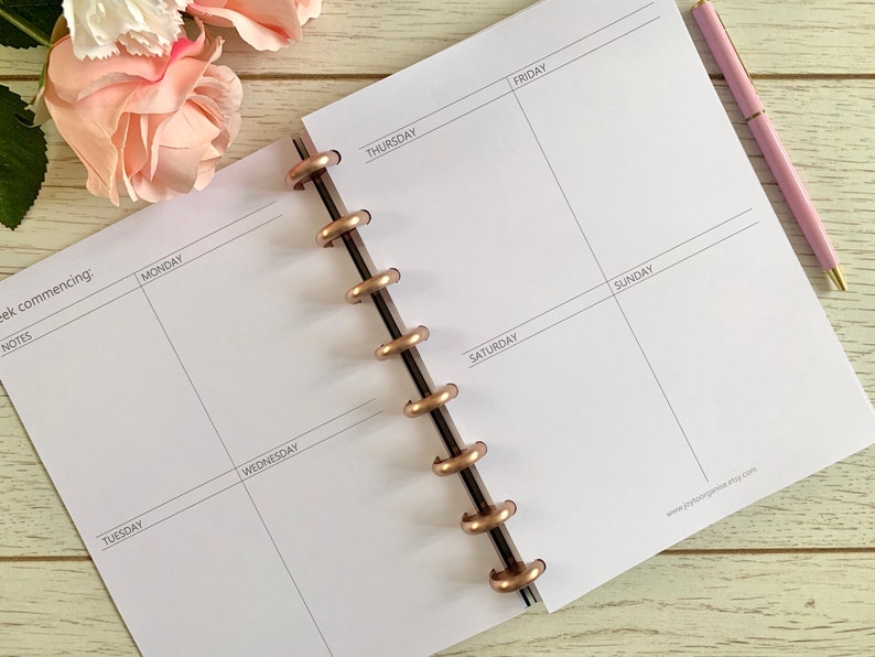 May include: A white weekly planner with a rose gold coil binding. The planner has spaces for notes, Monday through Sunday, and a section for the week commencing.