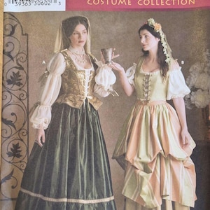 May include: Simplicity Renaissance Costume Collection pattern showing two women in Renaissance dresses. One dress is olive green with gold accents, the other is peach and green striped. Sizes 10, 12, and 14 are included.