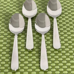 May include: A set of three ceramic nesting bowls in shades of blue, green, and white. The bowls feature a speckled glaze and a simple, modern design. The largest bowl is approximately 6 inches in diameter.