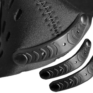 May include: Black face mask with two black adjustable straps. The straps have a textured pattern and a round button on each end.