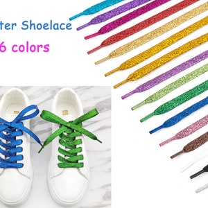 May include: A pair of white sneakers with blue and green glitter shoelaces. The image shows 16 different colors of glitter shoelaces.