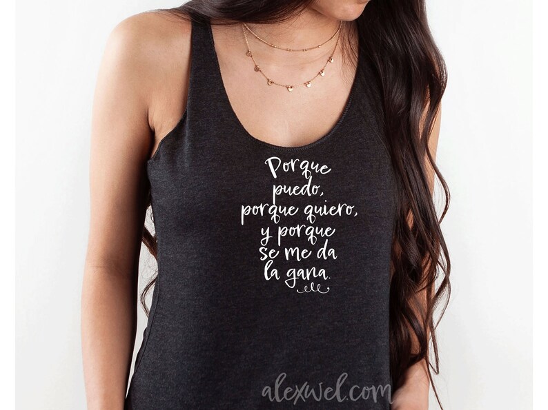 May include: A dark gray tank top with a white graphic that reads "Porque puedo, porque quiero, y porque se me da la gana."