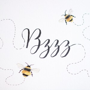 May include: A white background with the word "Bzzz" written in black cursive script. Two black and yellow bumblebees are flying with dotted lines showing their flight paths.