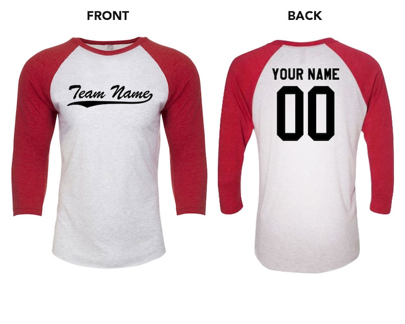 May include: A white and red baseball t-shirt with a three-quarter length sleeve. The front of the shirt has the text "Team Name" in a black cursive font. The back of the shirt has the text "YOUR NAME" in black block letters above the number "00" in black block letters.