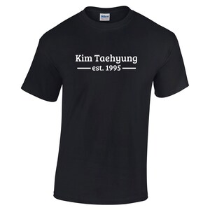 May include: Black t-shirt with white text that reads "Kim Taehyung - est. 1995".