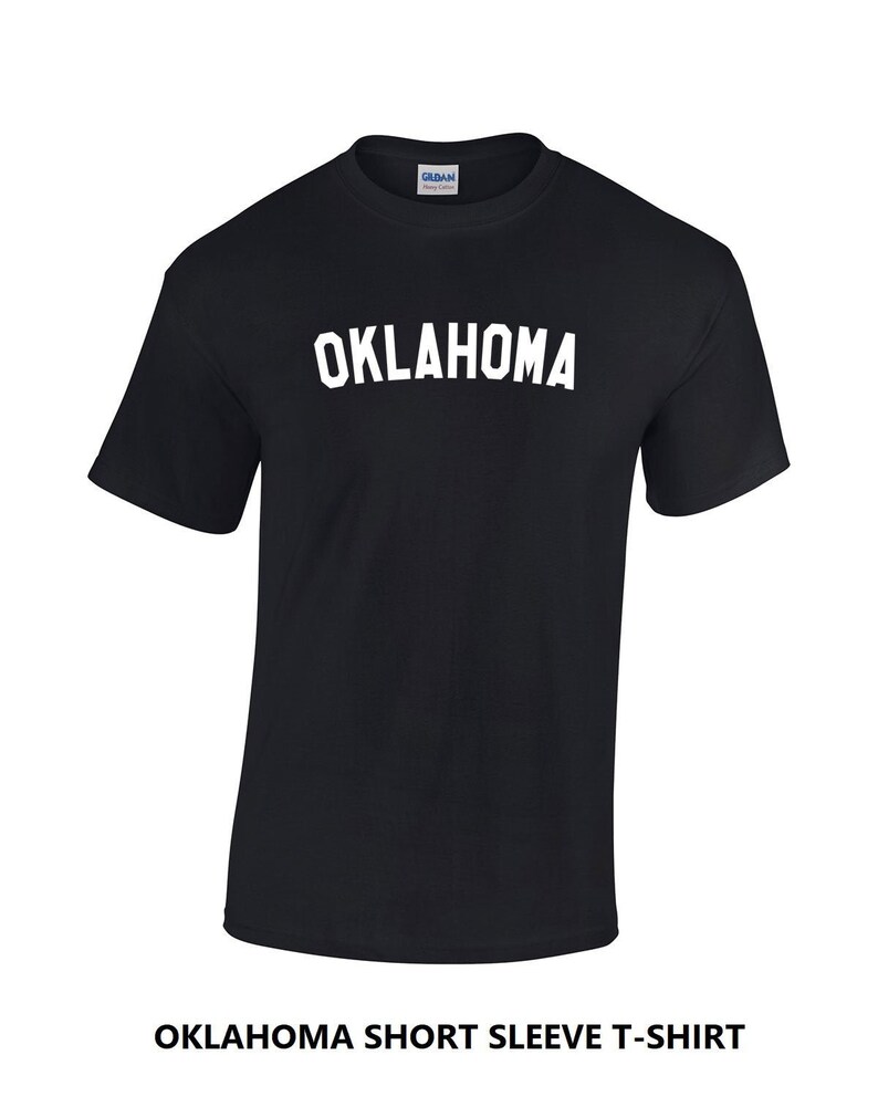 May include: Black short-sleeved t-shirt with white text that reads "OKLAHOMA".