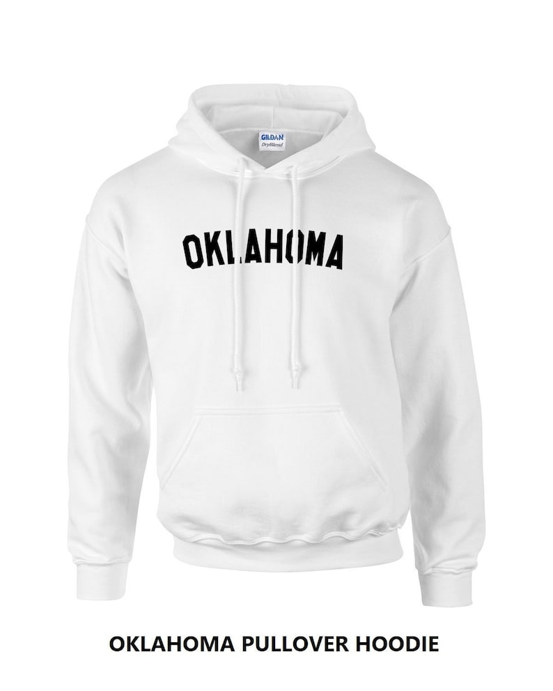 May include: White pullover hoodie with black text that reads "OKLAHOMA" on the front.