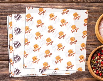 May include: A stack of white paper sheets with a repeating pattern of a burger and the word "Burger" printed in red. The paper sheets also have a small logo with the text "Bakehouse Daily Fresh" printed in brown.