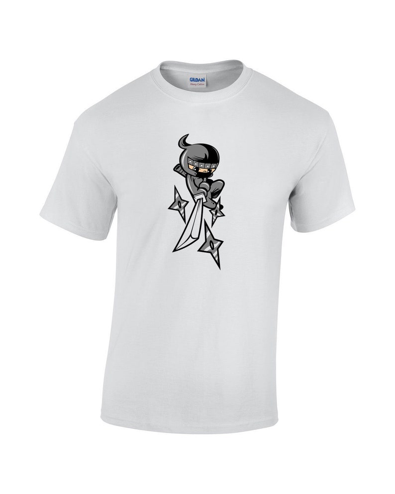 May include: White t-shirt with a cartoon ninja holding a sword and throwing stars.