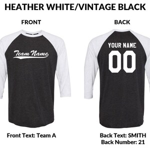 May include: Baseball jersey in a heather white and vintage black colour scheme. The front of the jersey features the text "Team Name" in a white cursive font. The back of the jersey has the text "YOUR NAME" in white block letters above the number "00" in white block letters.