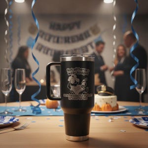 May include: A matte black stainless steel tumbler with a handle and a silver rim. The front features a white graphic of a cartoon turtle wearing a police hat, with the text: Not all heroes wear badges, some headbutt car doors to save turtles.