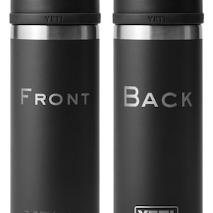 May include: A black YETI Rambler 12 oz. stainless steel insulated can cooler with a carrying handle. The front of the cooler has the word "FRONT" printed in white. The back of the cooler has the word "BACK" printed in white and the YETI logo printed in white.