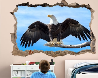 May include: A bald eagle with its wings spread wide sits on a branch against a blue sky. The eagle is looking to the right. The image is a wall decal that looks like a hole in the wall.
