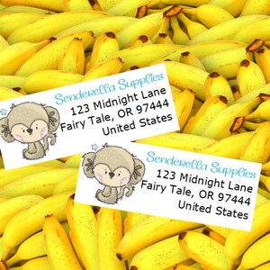 May include: Two white labels with a cartoon monkey illustration and the text "Senderella Supplies 123 Midnight Lane Fairy Tale, OR 97444 United States" on a background of yellow bananas.