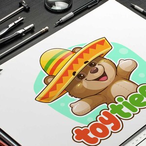 Cute cartoon bear logo wearing a colorful Mexican sombrero, with the text “Toy Tienda”, custom logo design by Beehaya Studio.