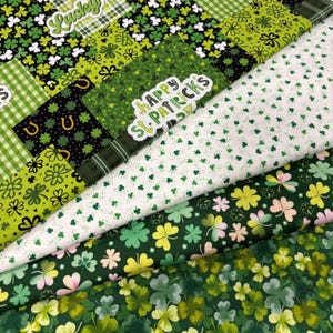 May include: A selection of green fabric pieces with St. Patrick's Day designs. Patterns include shamrocks, horseshoes, and the text "Happy St. Patrick's". The fabrics display shades of green, white, and black.