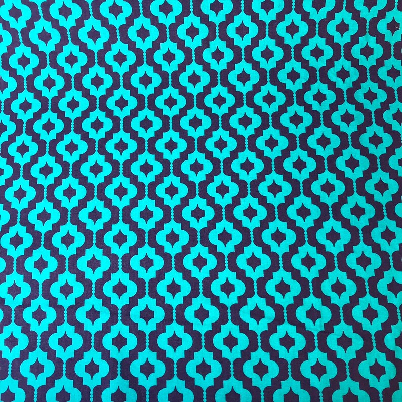 May include: Teal and dark blue geometric fabric with a repeating pattern of interlocking quatrefoils.