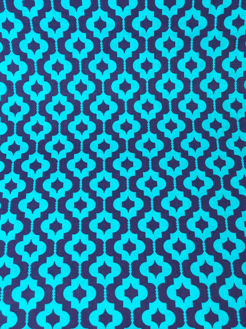 May include: A seamless pattern fabric with a repeating geometric design. The pattern features teal blue and dark purple interlocking shapes.