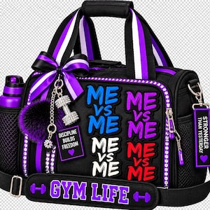 May include: A black gym bag with purple and white striped handles, featuring the text ME VS ME in blue, purple, white, and red. It includes a purple water bottle, a purple bow, a dumbbell charm, and a tag reading DISCIPLINE BUILDS FREEDOM.