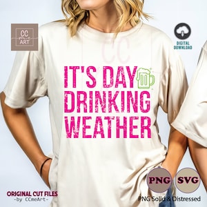 May include: A white t-shirt with the text "It's Day Drinking Weather" in pink with a green beer mug graphic.