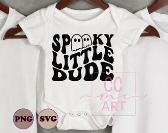 May include: White baby bodysuit with the text "Spooky Little Dude" in black, along with two ghost illustrations. The bodysuit is hanging on a wooden hanger. The image also includes PNG and SVG icons.