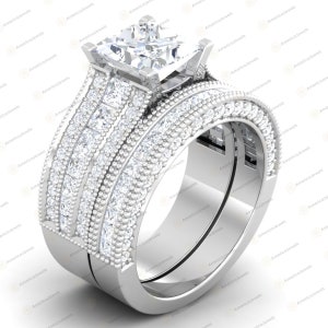 May include: A silver wedding ring set with a large square-cut centre stone and a band with multiple rows of smaller stones.