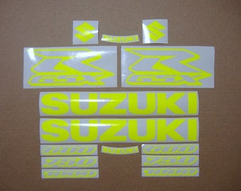 May include: A set of yellow motorcycle decals with the Suzuki logo and the text "GSXR" and "600 750 1000".