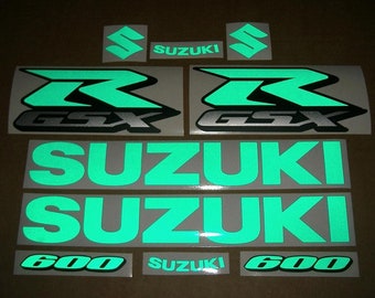 May include: A set of green and black motorcycle decals with the text "GSX-R" and "SUZUKI 600".