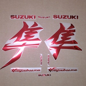 May include: Red and silver motorcycle decals with the word "Suzuki" and the Japanese characters for "Suzuki" and "Hayabusa".