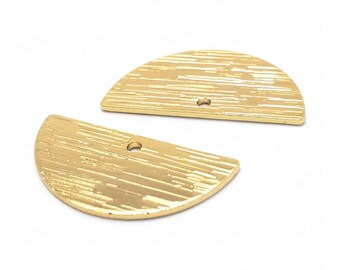 May include: Two gold-colored metal half-circle shapes with a textured surface and a hole in the center.