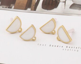 May include: Three gold-toned half-circle charms with white enamel. Each charm has a small loop at the bottom.