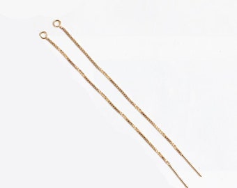 May include: Two gold chain earring extenders with jump rings at the top and a straight end.