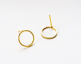 May include: A pair of gold circle earrings. The earrings are simple and elegant, and would make a great gift for any occasion.