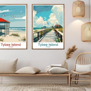 May include: Two framed art prints depicting Tybee Island, Georgia. One shows a beach with a red-roofed structure, the other a wooden walkway. Both have the text "Tybee Island Georgia". The prints are in wooden frames.