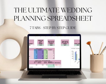 May include: A laptop computer displaying a wedding planning spreadsheet with seven tabs. The spreadsheet includes sections for budget summary, detailed breakdown, and a chart showing total savings. The laptop is on a white surface with a vase of paintbrushes.