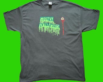 May include: A dark grey t-shirt with a green and red graphic that says "Mouthy Halloween!"