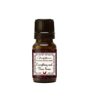 May include: A small brown glass bottle with a black cap. The bottle has a label that says "Dorothy Morrison's Wicked Witch Mojo Everything and Then Some".