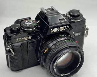 Cámara Minolta X-700 de 35 mm en excelente estado, con objetivo de 50 mm, revisada profesionalmente y con 90 días de garantía.