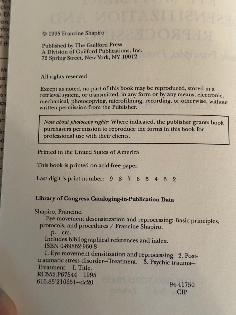 May include: A printed page from a book titled "Eye movement desensitization and reprocessing" by Francine Shapiro. The text includes publication information from The Guilford Press, copyright 1995, and Library of Congress data. The book is printed in the United States.