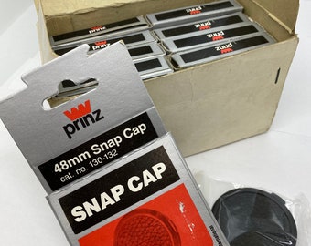 Pkg of 10 rare Telesor 48mm lens caps new in packaging!