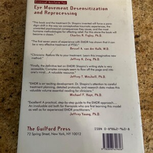 May include: The back cover of a book titled "Eye Movement Desensitization and Reprocessing." The cover is white with black text, including quotes and author names. The Guilford Press logo and ISBN are also visible.