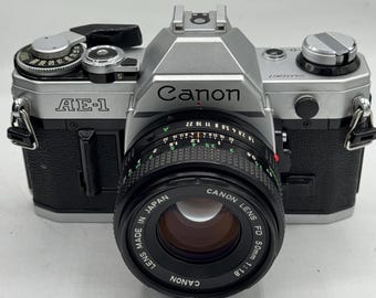 Canon AE-1 35mm film camera with 50mm f/1.8 lens excellent plus condition professionally serviced with 90 day warranty!