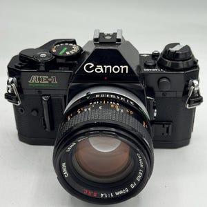 Rare black body Canon AE-1 Program 35mm film camera with fast 50mm f/1.4 lens professionally serviced with 90 day warranty!