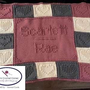May include: A pink, white and grey crocheted baby blanket with the name "Scarlett Rose" in the centre. The blanket is made with a textured stitch and has a heart pattern on the border.