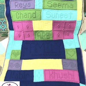 May include: A colorful crocheted blanket with the words "Seema Chand Suneet", "WE ARE", and "FAMILY" in a block pattern. The blanket is made with different colored squares, including purple, green, yellow, blue, and pink.