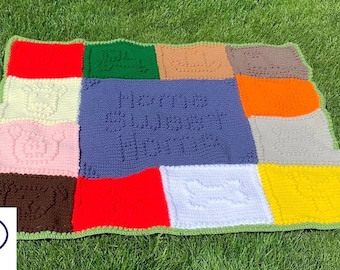 Pode incluir: Um cobertor de bebé em crochet multicolorido com uma variedade de texturas e padrões. O quadrado central é roxo e apresenta o texto "Mommy's Sweetest Heart".