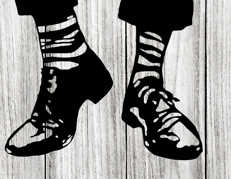 May include: A pair of black shoes with white striped socks. The shoes are on a wooden surface.